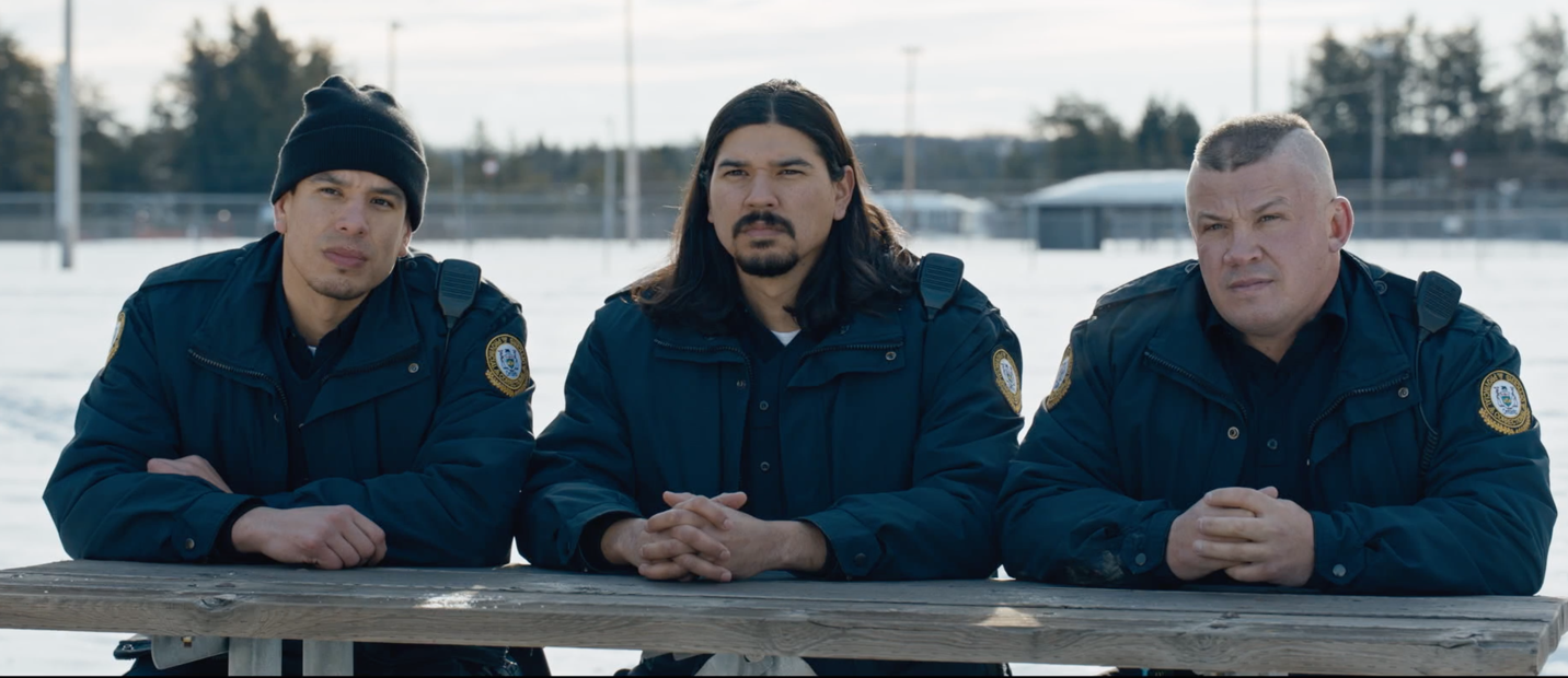A group of men in blue jackets