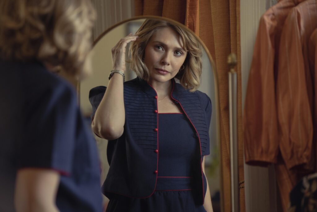 Elizabeth Olsen looks at herself through a mirror in HBO Max's LOVE & DEATH
